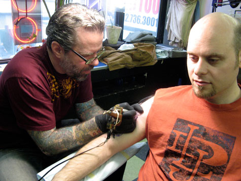 Mike Bellamy of Red Rocket Tattoo giving me the business (photo by Amy).